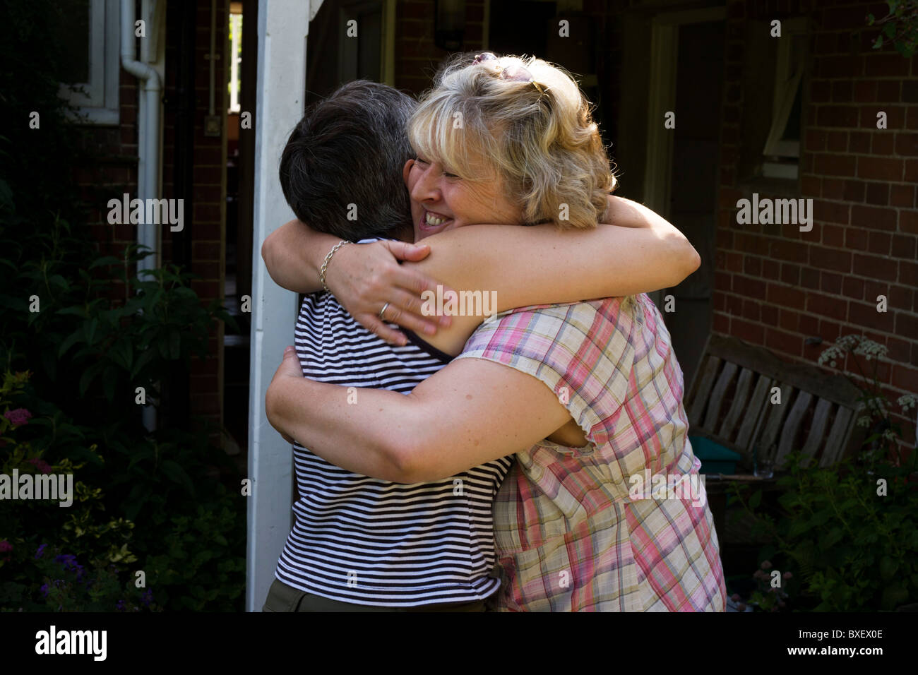 Friends say farewell after weekend together at the Rivendell Buddhist Retreat Centre, East Sussex, England. Stock Photo