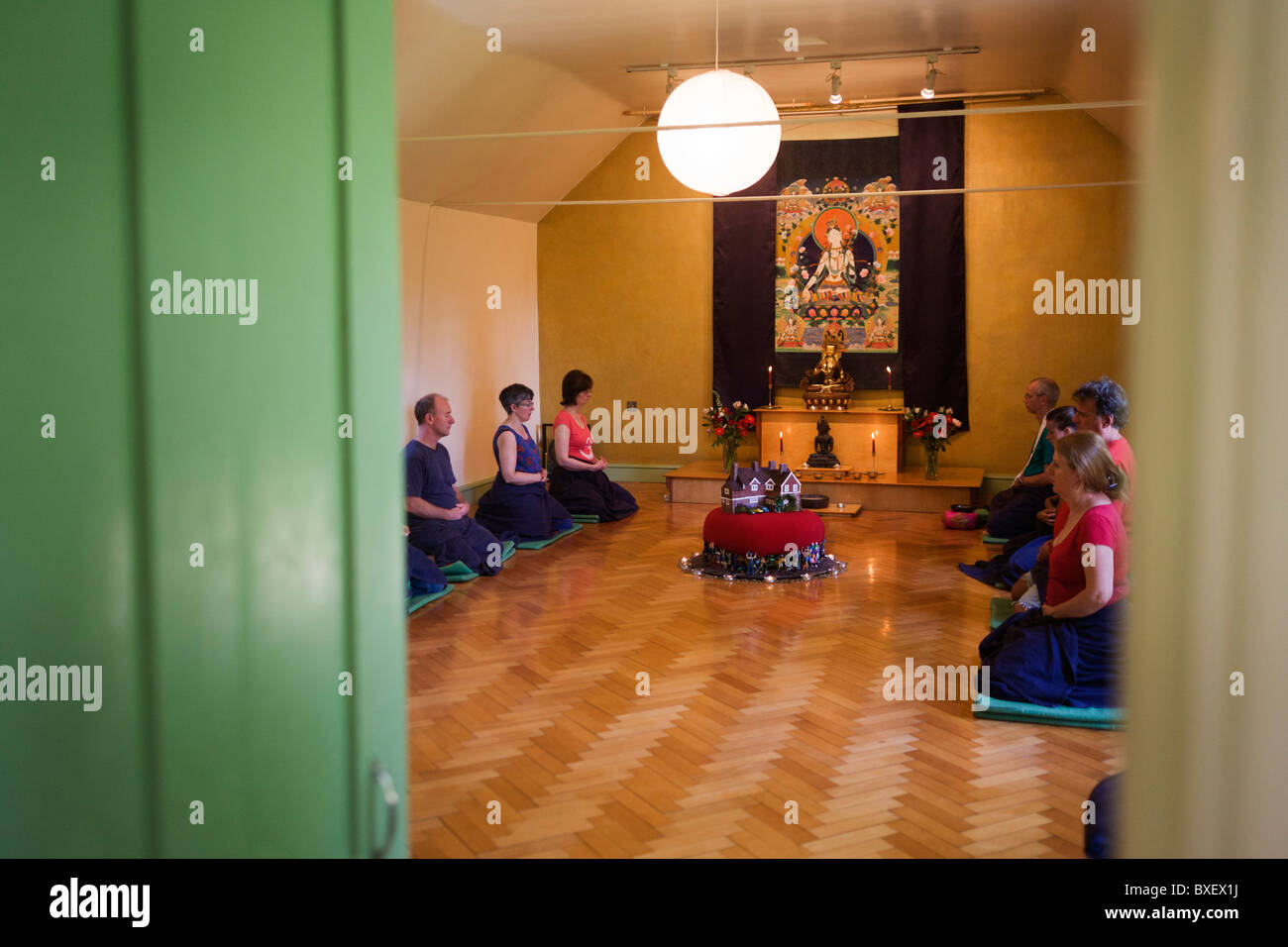 Buddhists meditate in silence for 30 minutes in their Shrine Room at the Rivendell Buddhist Retreat Centre, England. Stock Photo