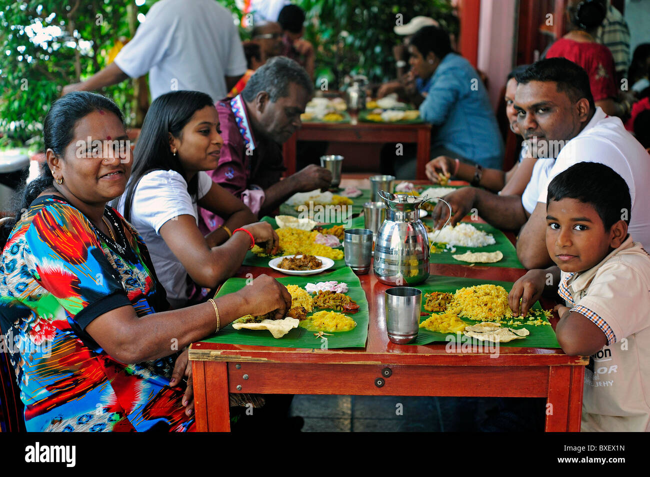 Indian family eating meal together in Little India Singapore Stock Photo