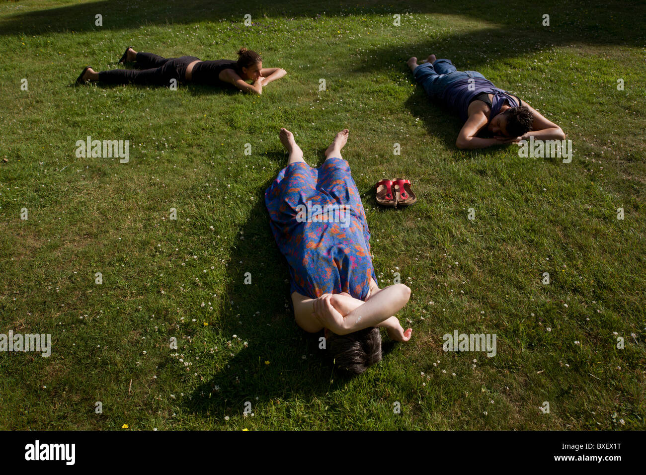 Volunteers doze on lawn after long working day at the Rivendell Buddhist Retreat Centre, East Sussex, England. Stock Photo