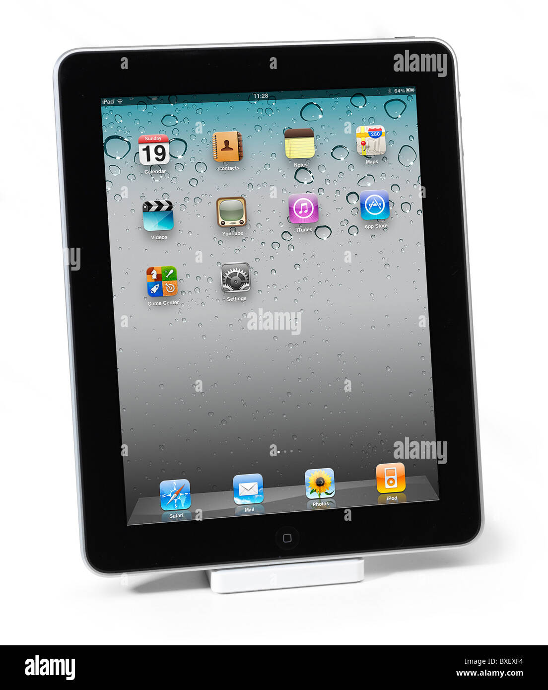 First Apple iPad with 4.2 screen shown in iPad dock on white background Stock Photo