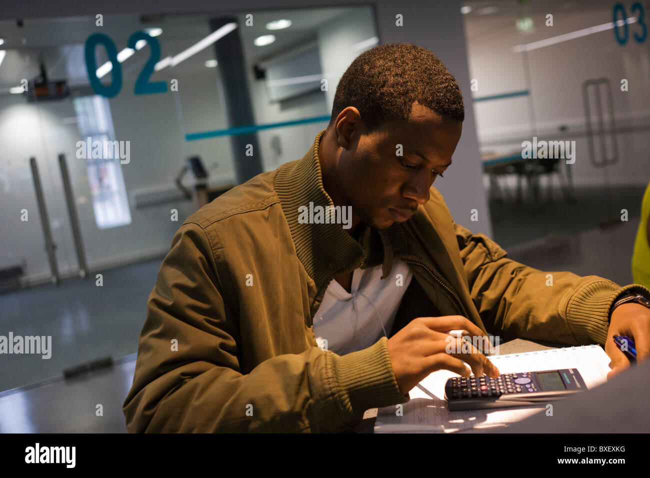 Young men study at workstations in communal area at London Metropolitan University's Holloway Road campus. Stock Photo