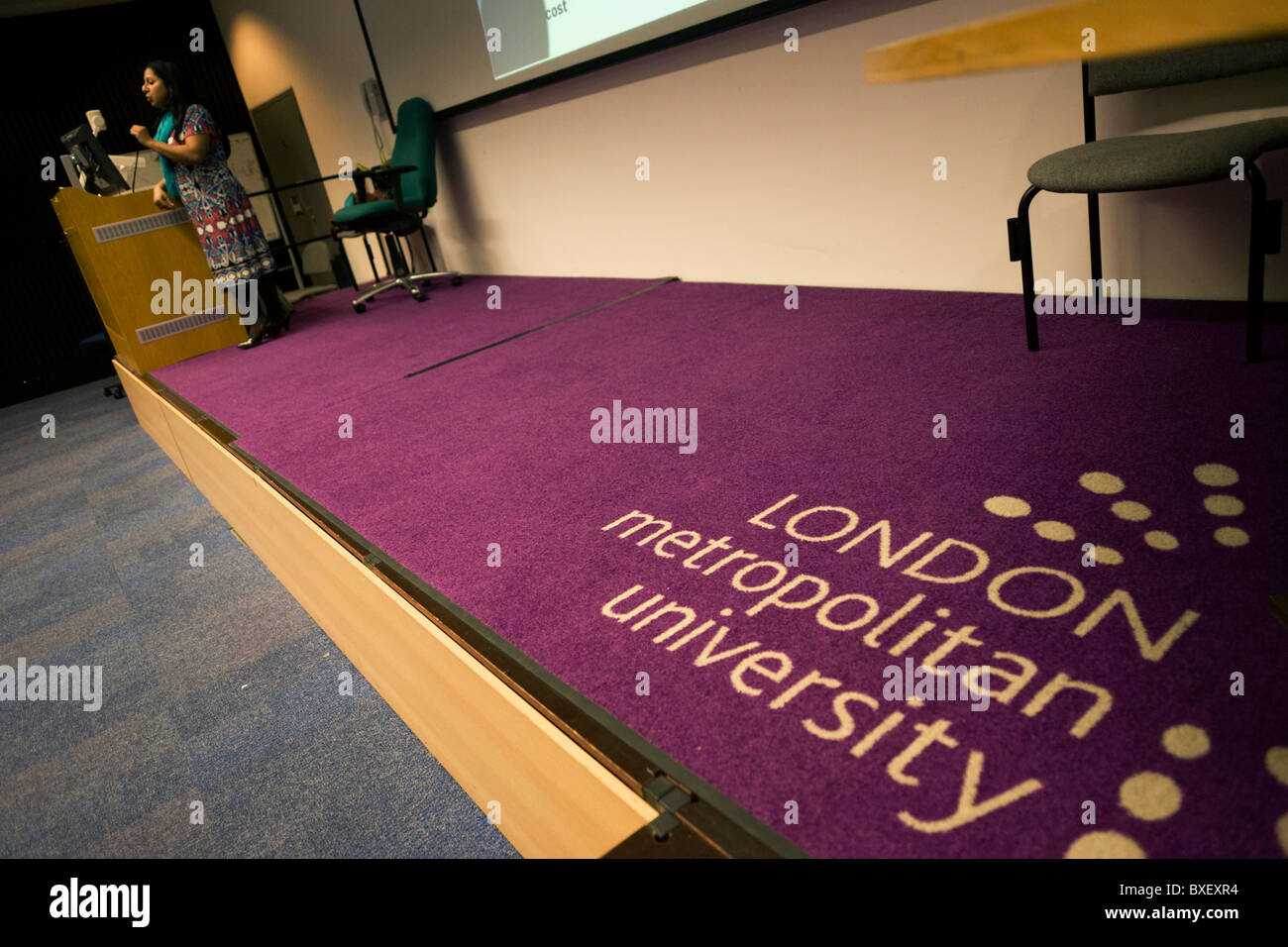 Purple corporate logo on lecture theatre carpet of London Metropolitan University's Holloway Road. Stock Photo