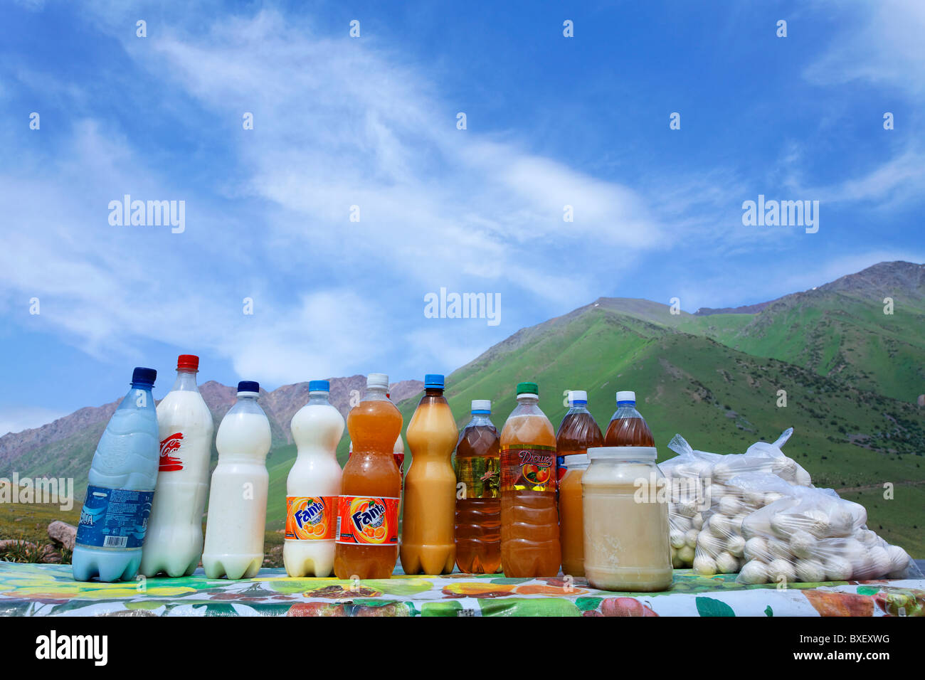 Kyrgyzstan - roadside market stalls selling dried milk balls and honey and mare's milk in recycled plastic bottles Stock Photo