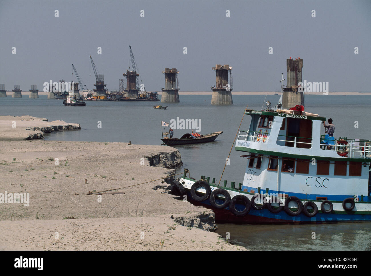 Motor boats help move workers and construction material around the 4.8 km Jamuna Bridge project. Stock Photo