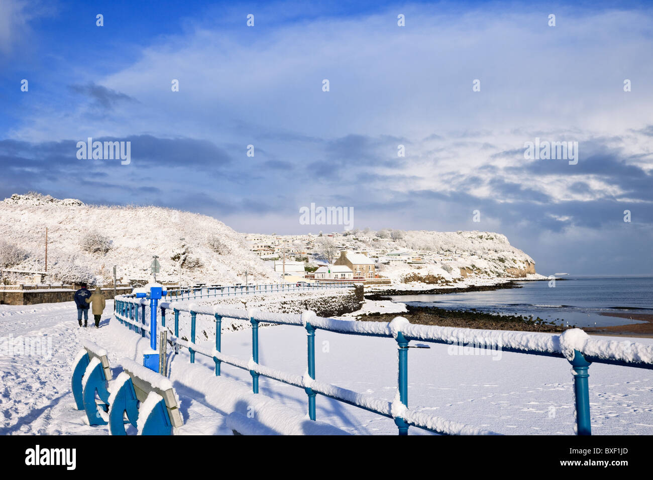 Snow on the seafront railings and beach on Welsh coast in winter 2010. Benllech, Isle of Anglesey, Wales, UK, Britain Stock Photo