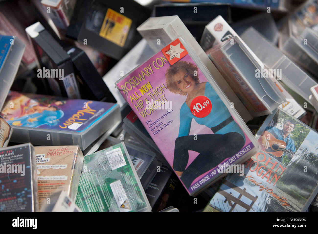 Old VHS tapes in a bargain bin. Stock Photo