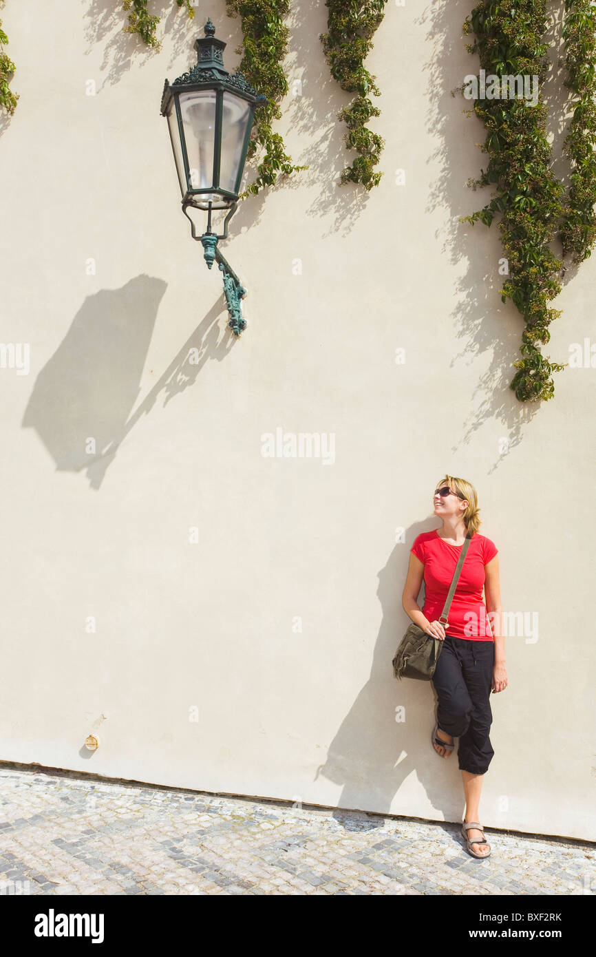 Woman standing under a large street lamp in Prague,Czech Republic Stock Photo