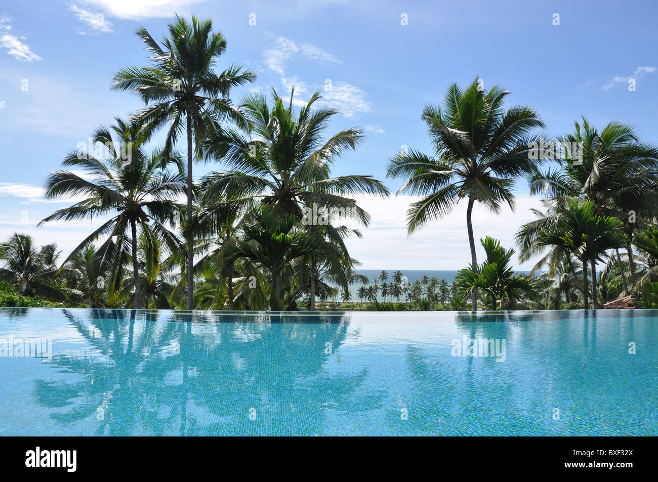 View over infinity swimming pool and sea at the Taj Green Cove Hotel Kerala Kovalam India southern India Stock Photo