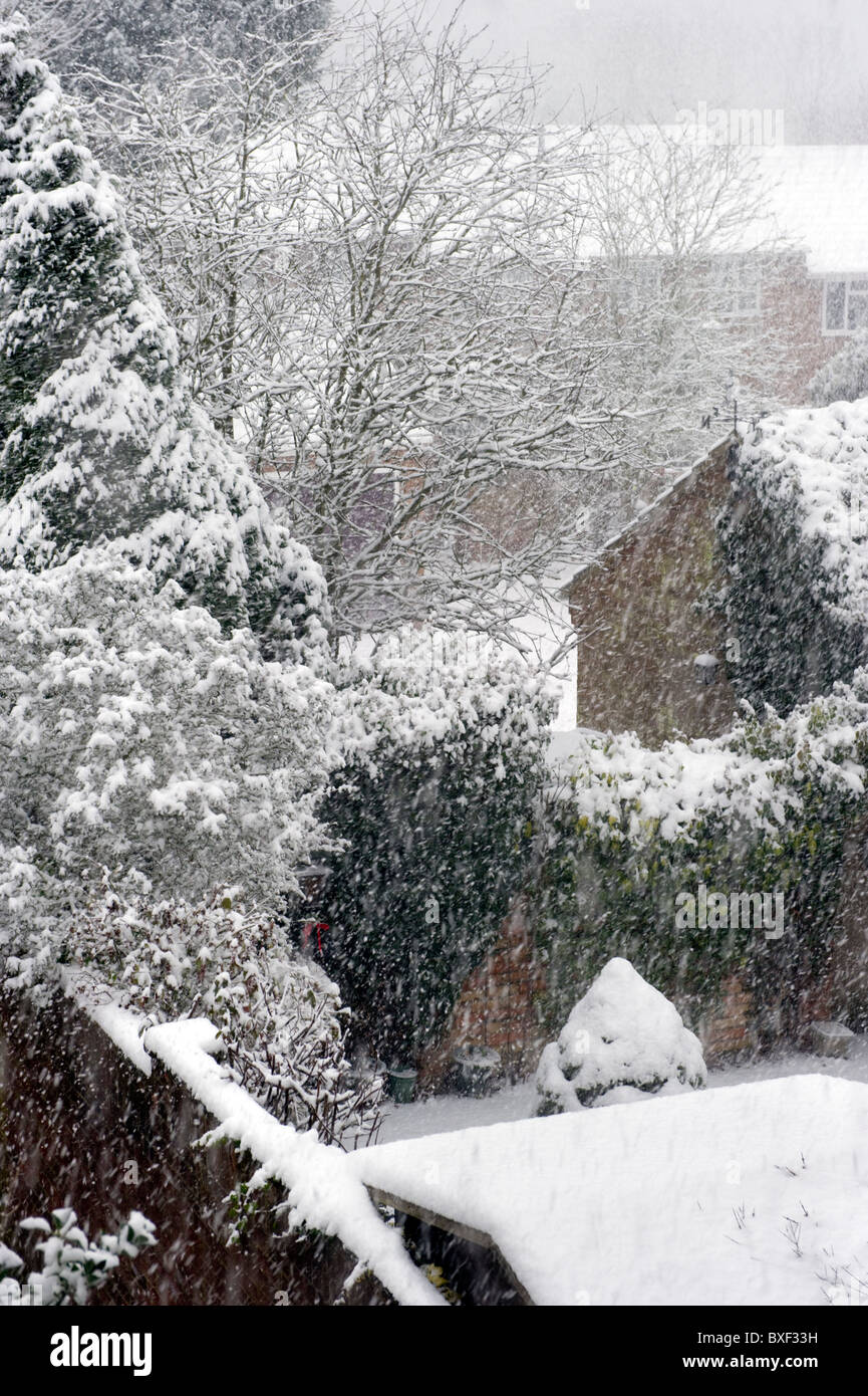 view of houses and gardens in a heavy snowfall and Winter blizzard weather Stock Photo