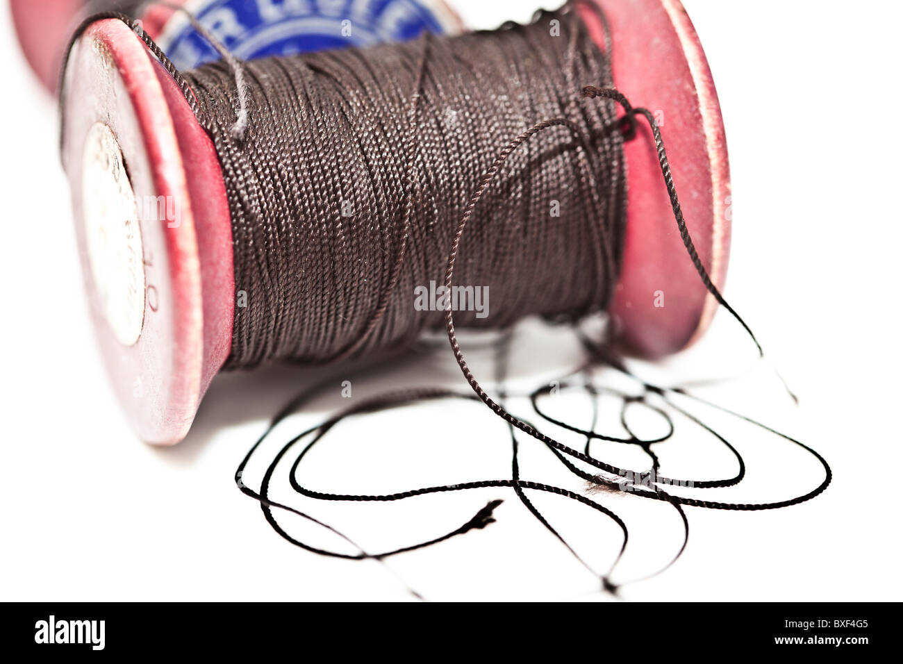 Cotton thread reel sew macro close up photograph hi-res stock