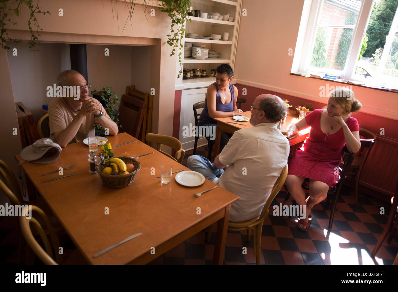 Mealtime for visitors in dining room at the Rivendell Buddhist Retreat Centre, East Sussex, England. Stock Photo