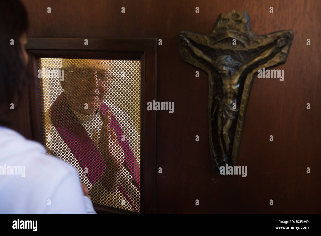 Confessional between penitent and priest at St. Lawrence's Catholic church in Feltham, London. Stock Photo
