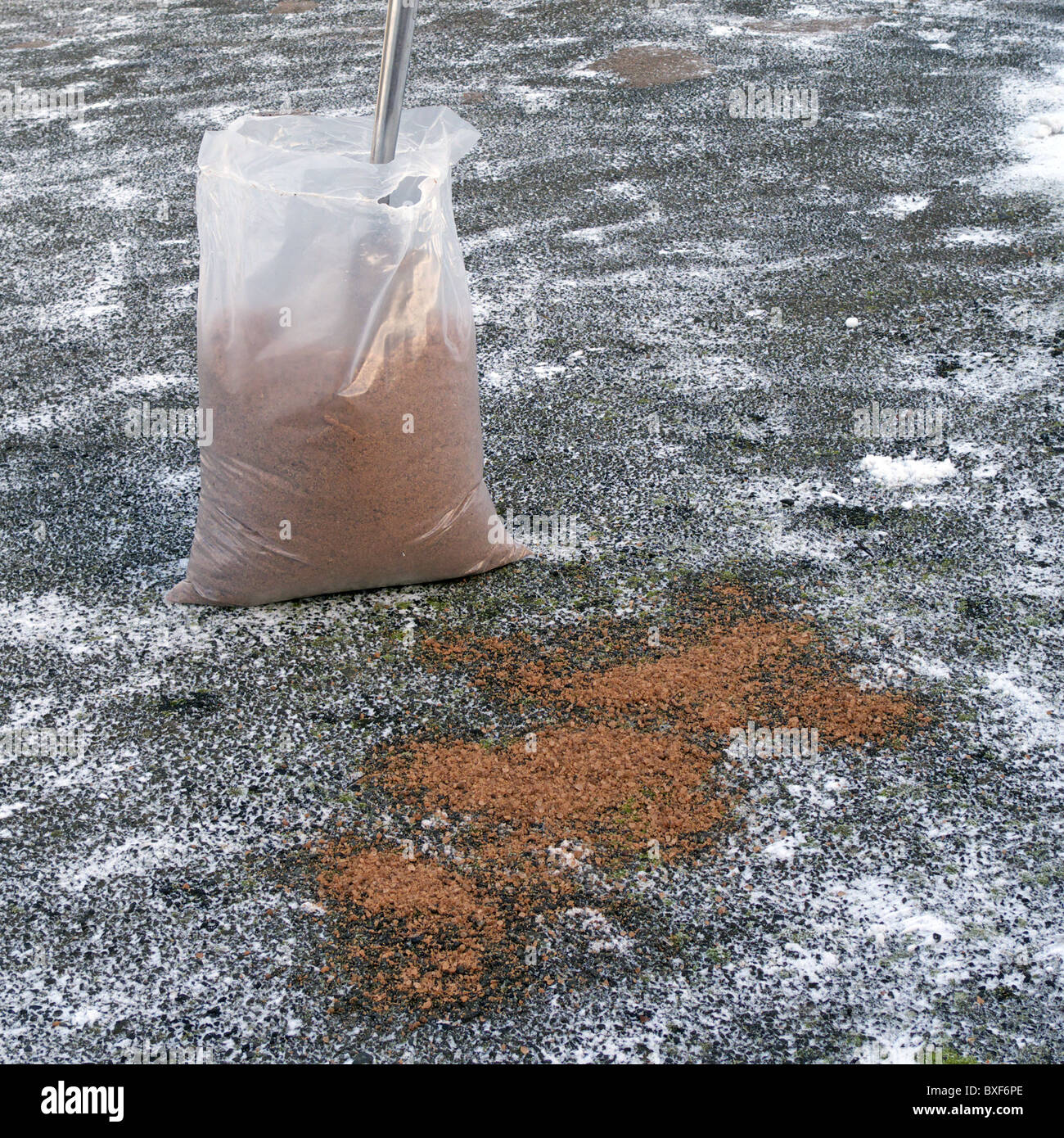 Bag of Rock Salt (Grit) on an Icy Driveway with Spade Stock Photo Alamy