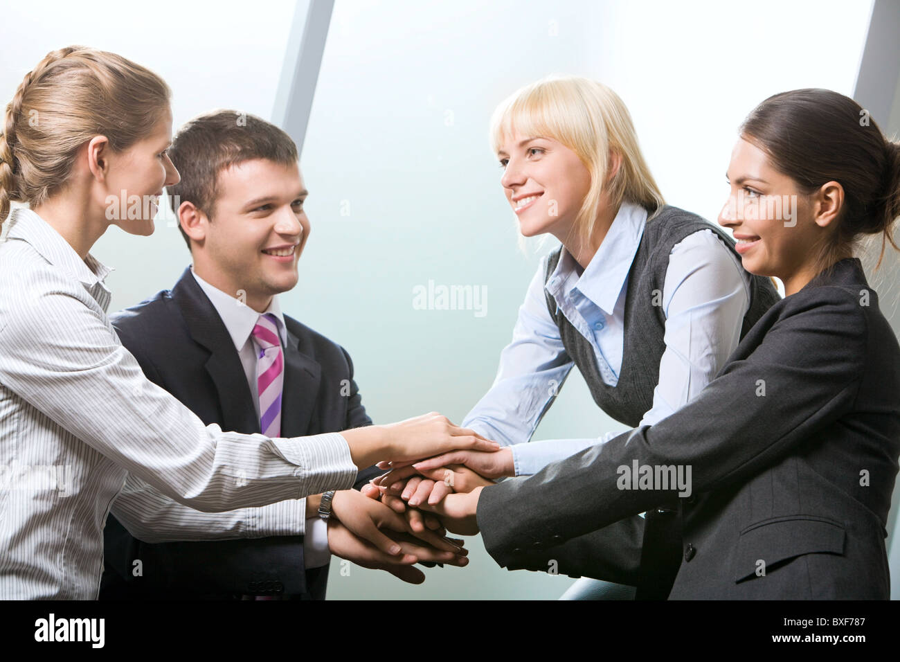 Business team putting their hands on top of each other Stock Photo - Alamy