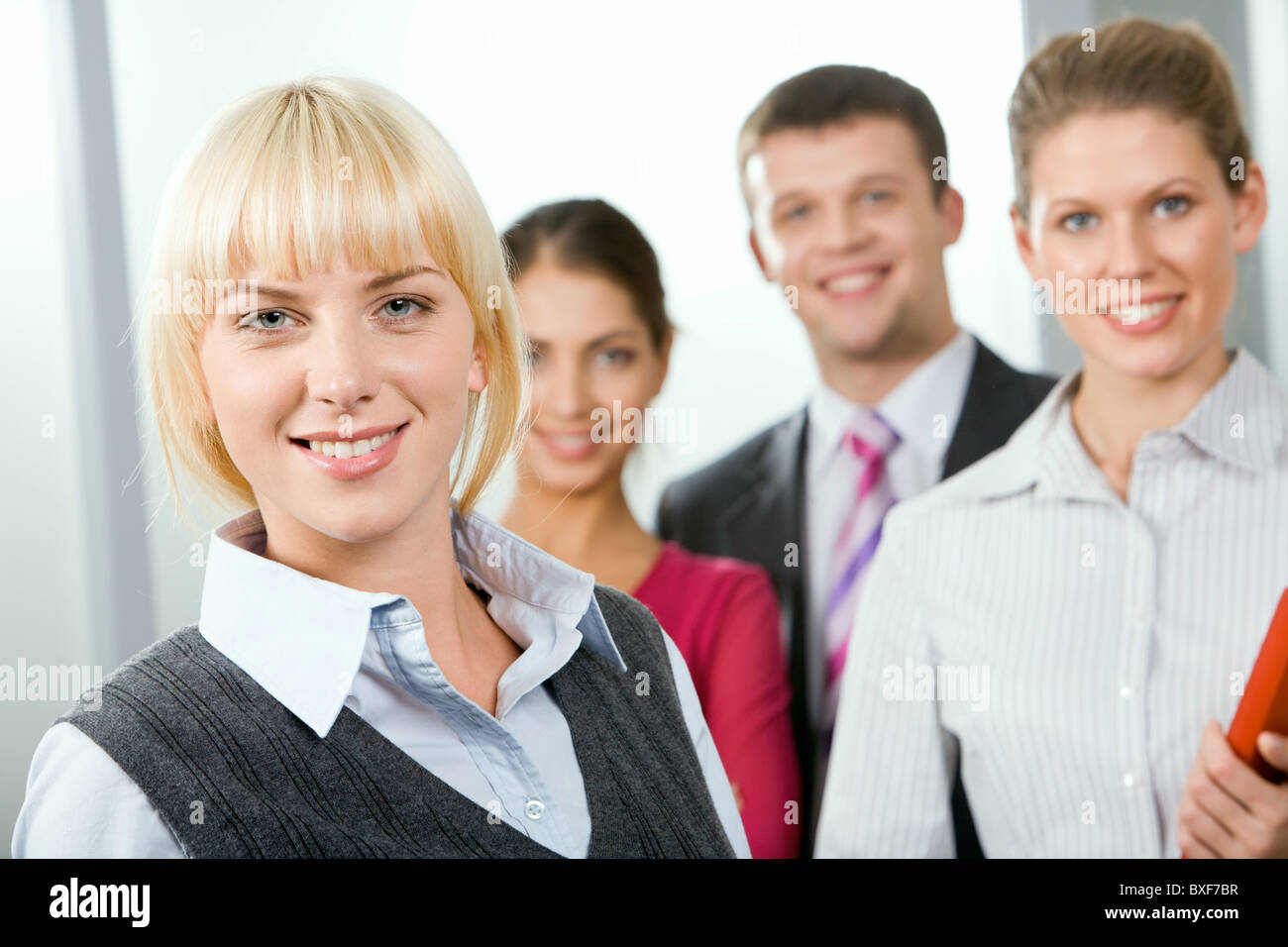 Female leader on the background of her business team Stock Photo - Alamy