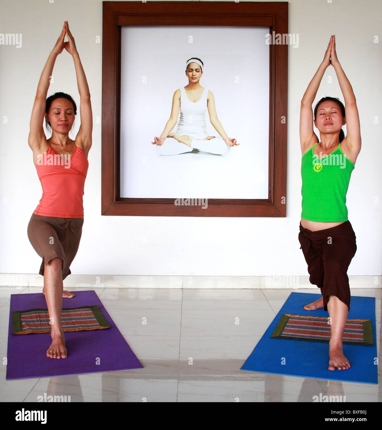 two Asian women doing Yoga Stock Photo - Alamy