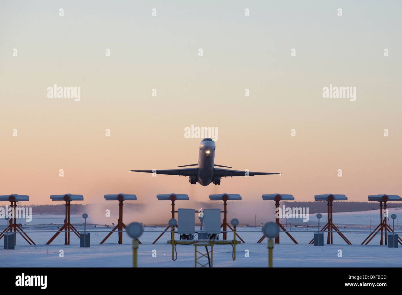 An airplane taking off on a cold snowy winter morning Stock Photo Alamy