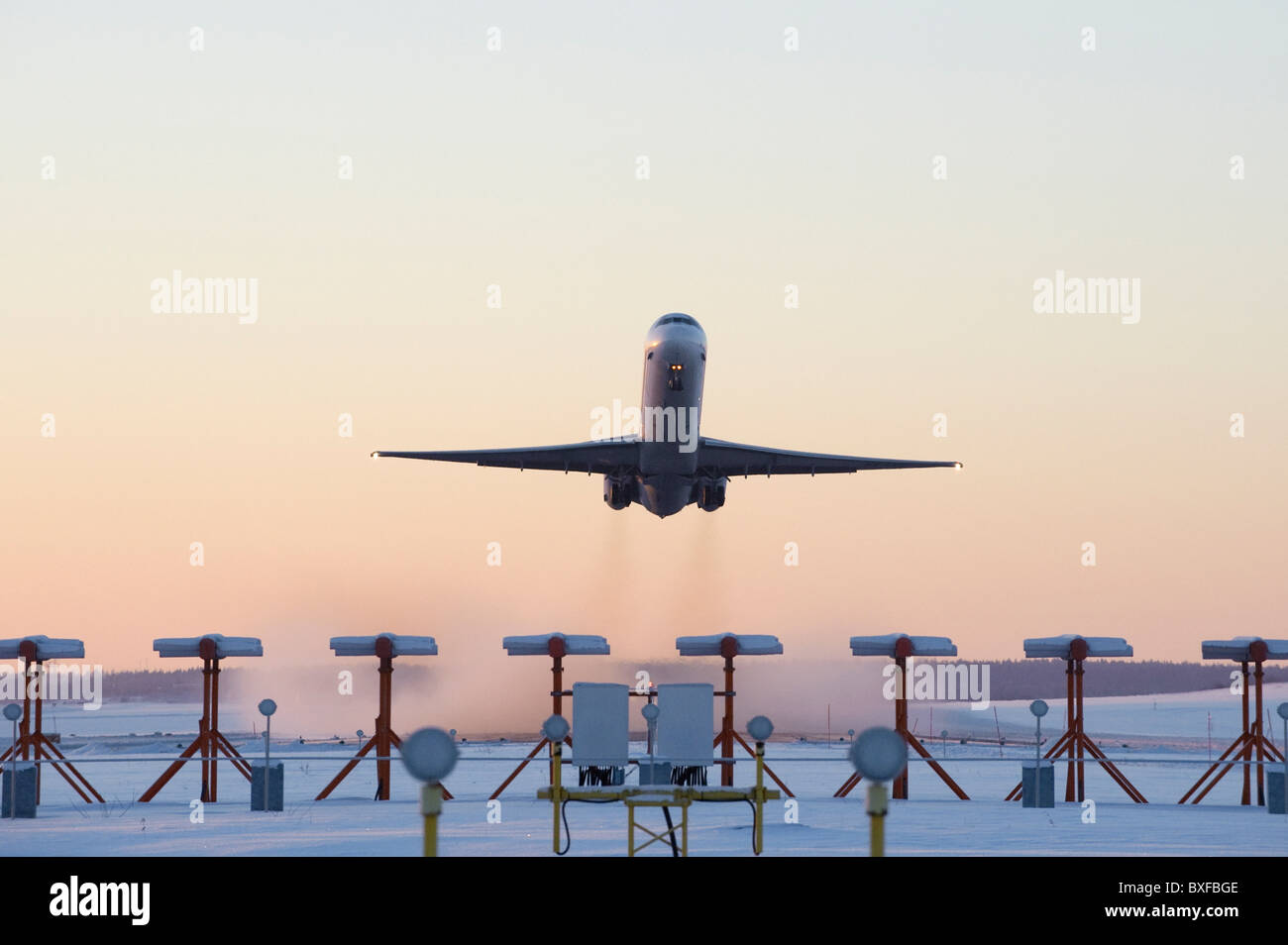 An airplane taking off on a cold snowy winter morning Stock Photo Alamy