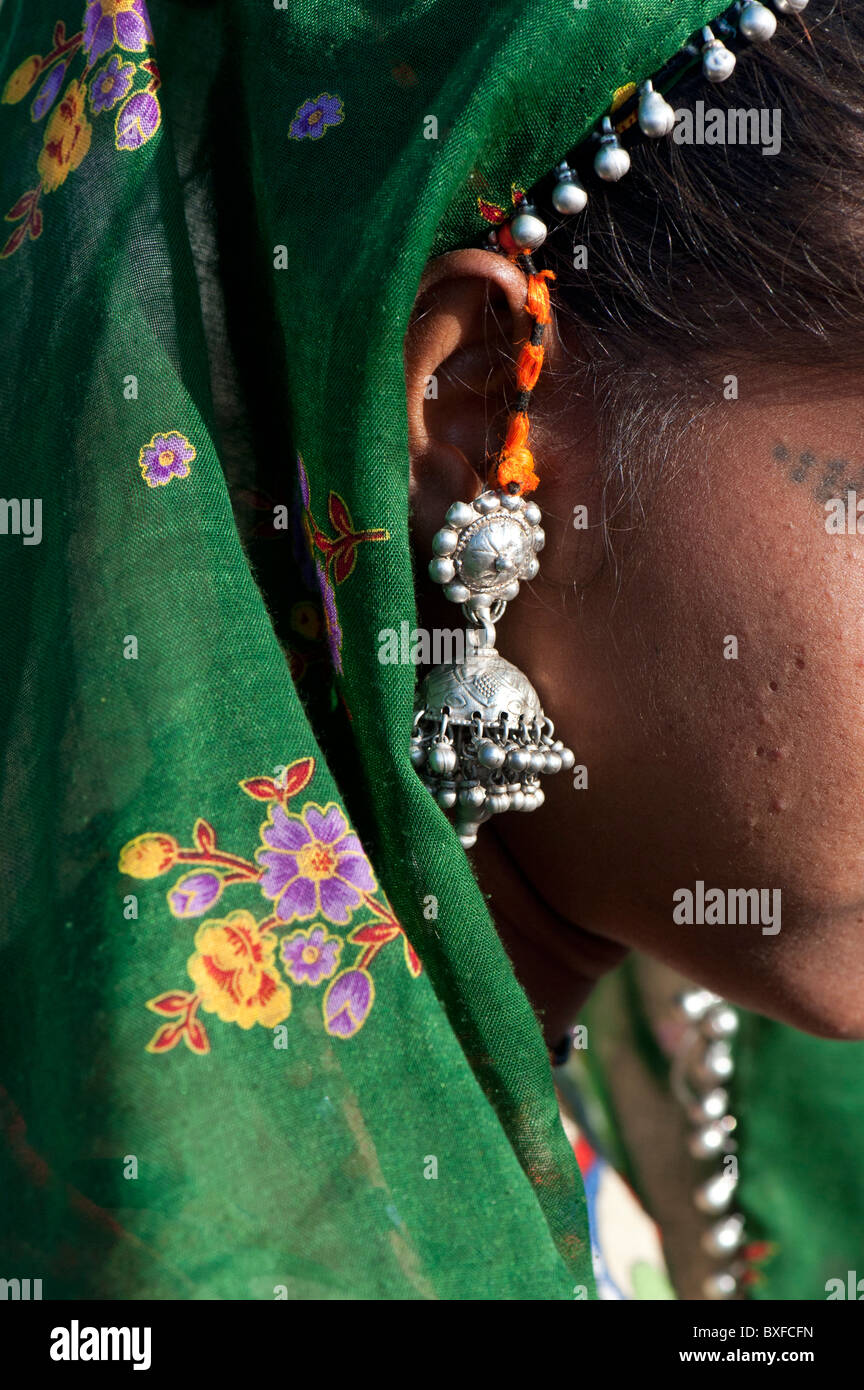 Gadia Lohar. Nomadic Rajasthan teenage girls earring and head scarf. Abstract. India's wandering blacksmiths. India Stock Photo