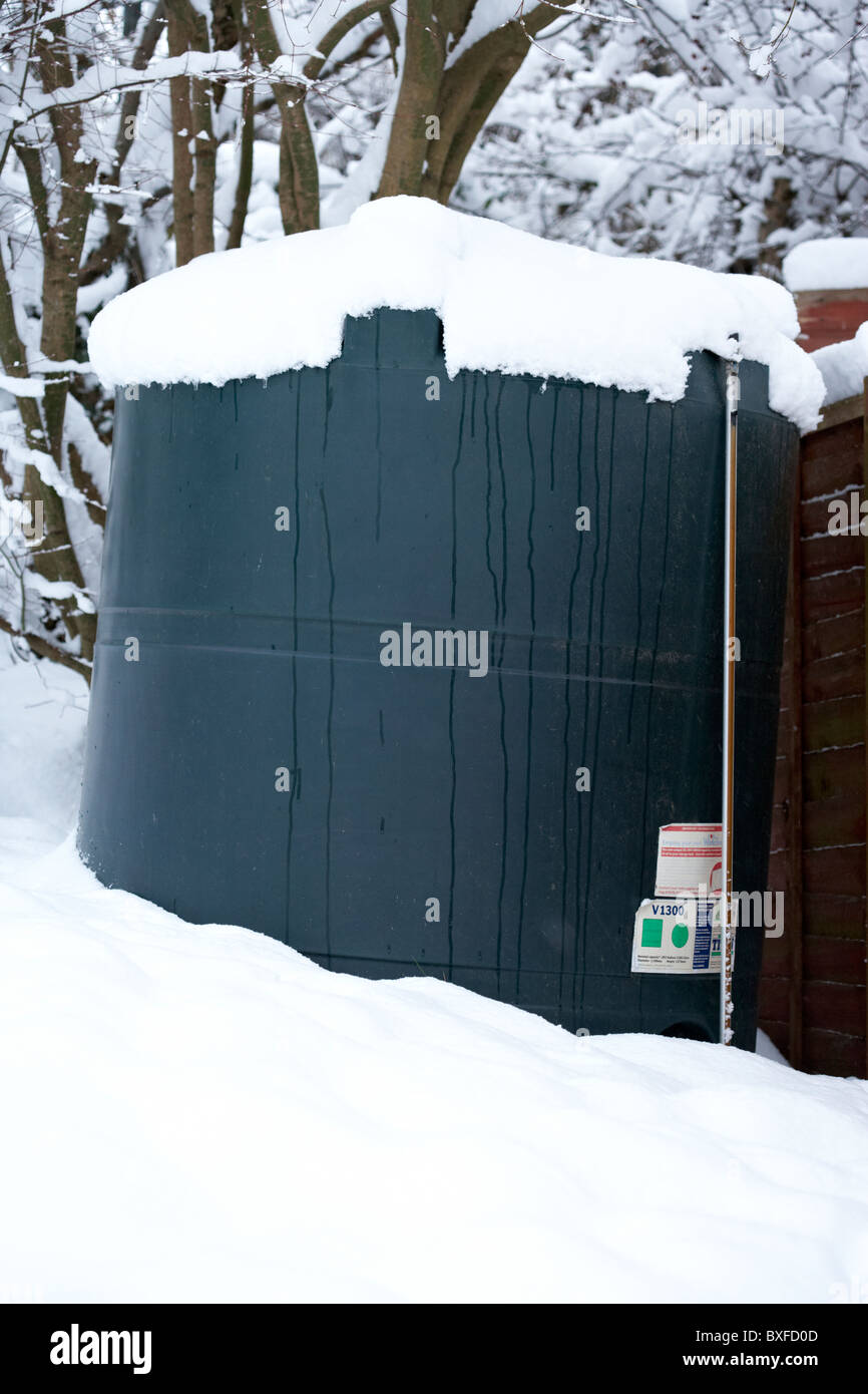 home heating oil tank covered in snow on a cold snowy winters day Northern Ireland Stock Photo