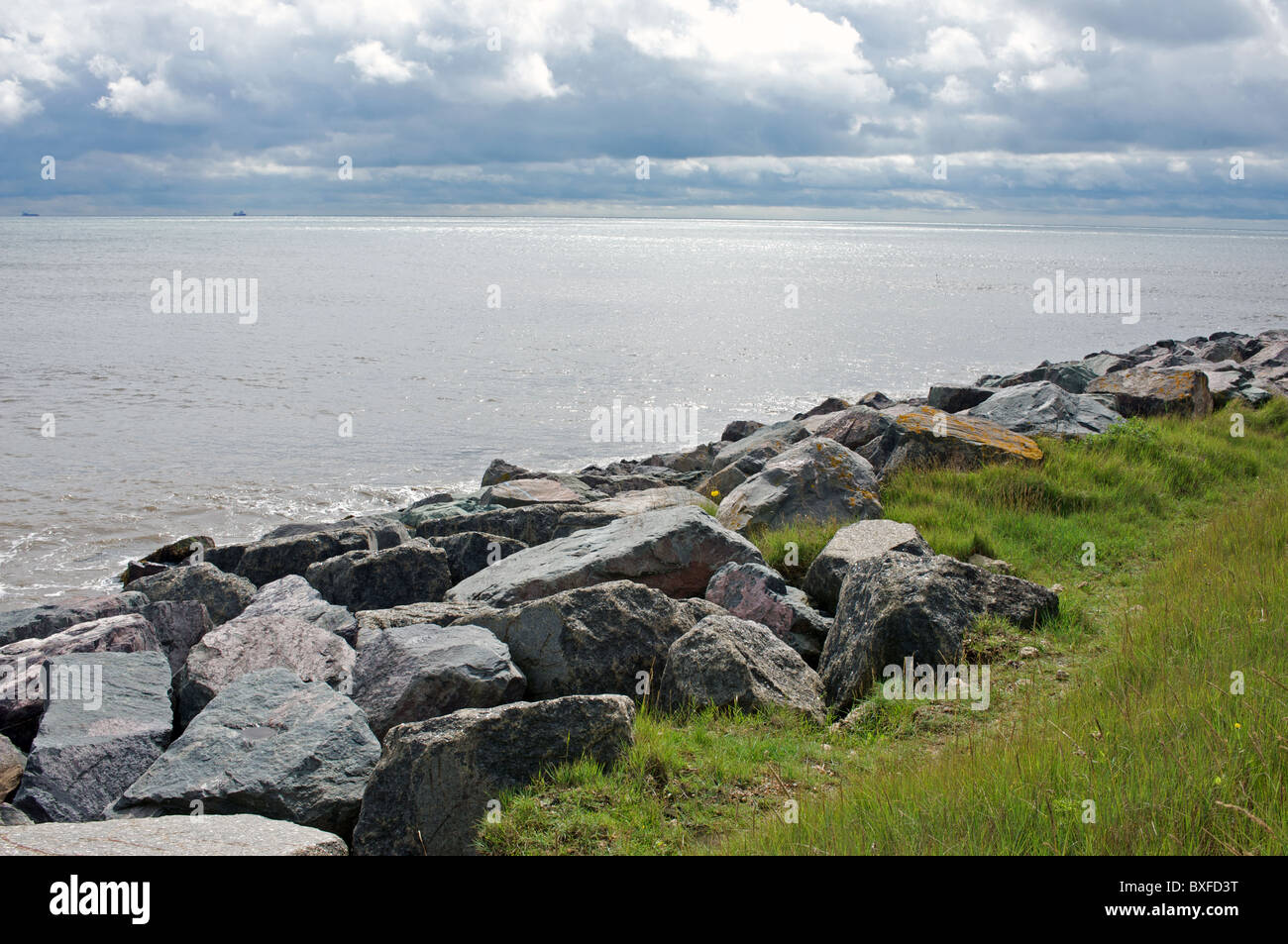 Rock armour protecting coastline from erosion Stock Photo
