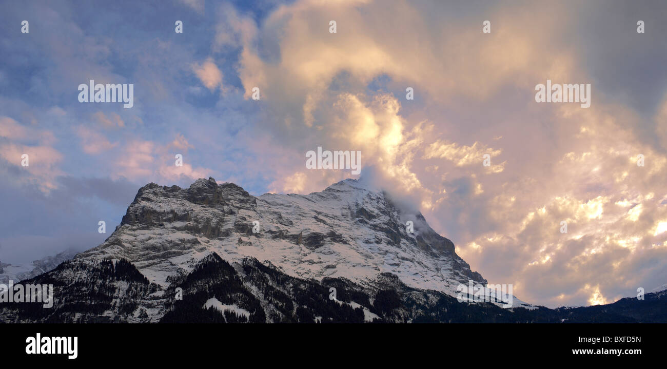 Sunset and clouds over the sumit of the North Face of the Eiger Stock Photo