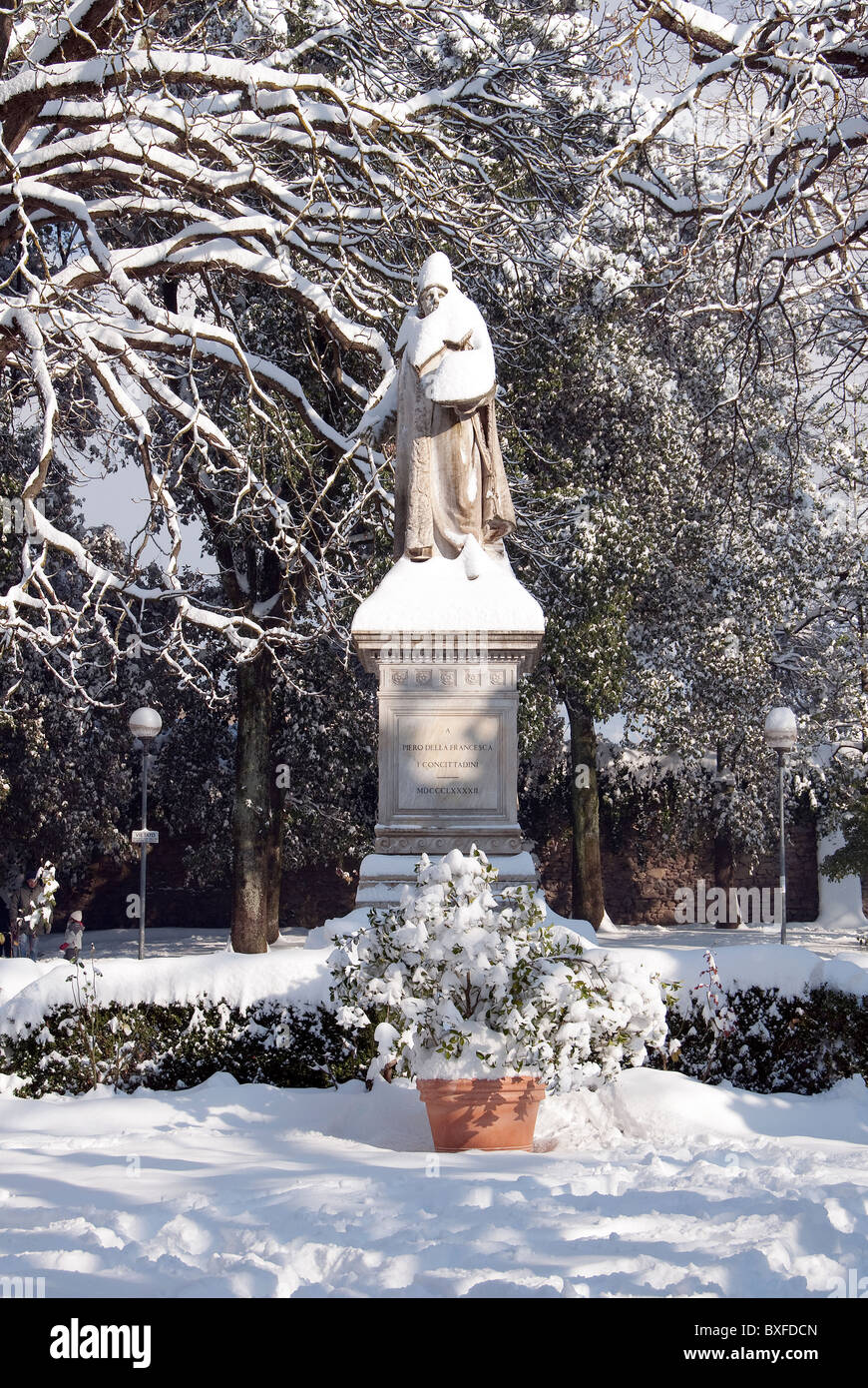 Statue of Piero della Francesca in the public garden in the Tuscan town of Sansepolcro in December snow Stock Photo