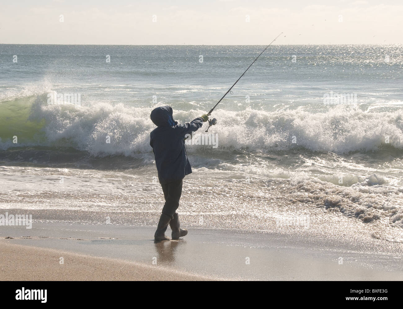 Man wearing cowboy hat checks net for catch before casting into surf on  Mendocino California coast Stock Photo - Alamy