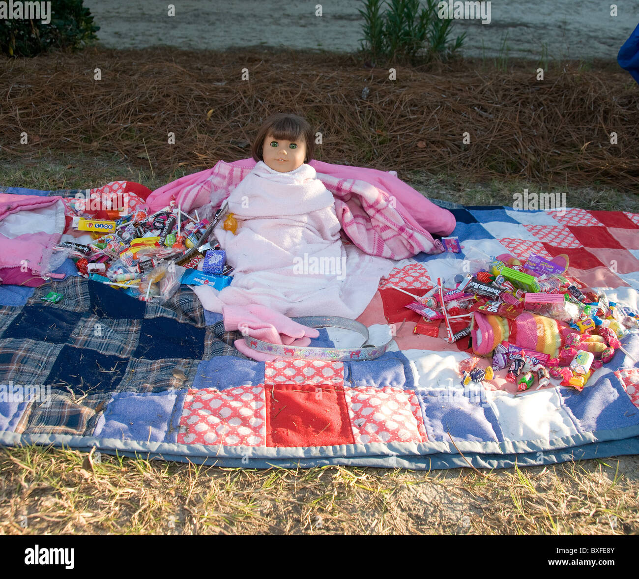 Doll baby on blanket with candy Stock Photo Alamy
