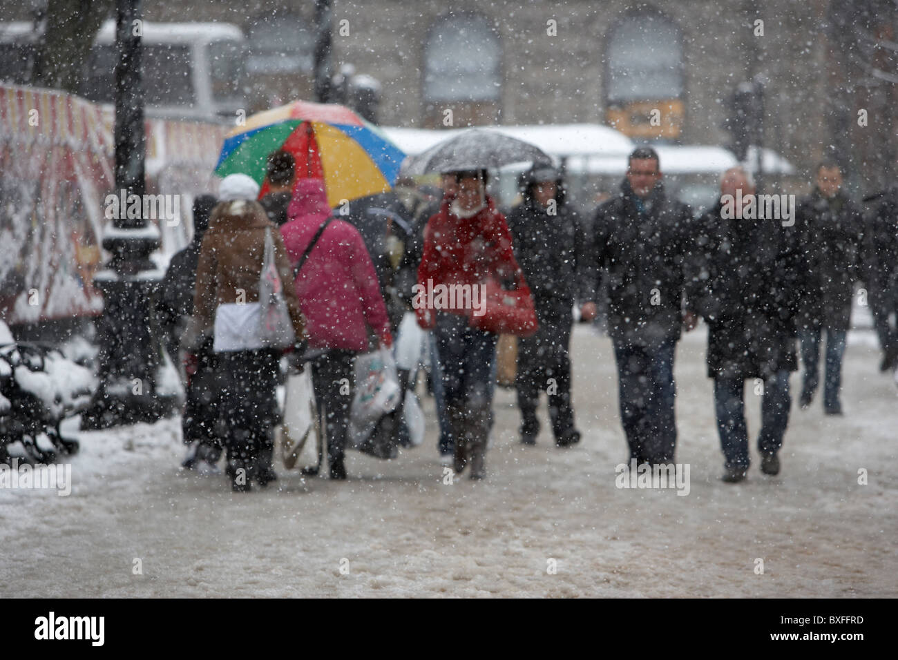 defocussed people out christmas shopping on a cold snowy winters day Belfast Northern Ireland Stock Photo