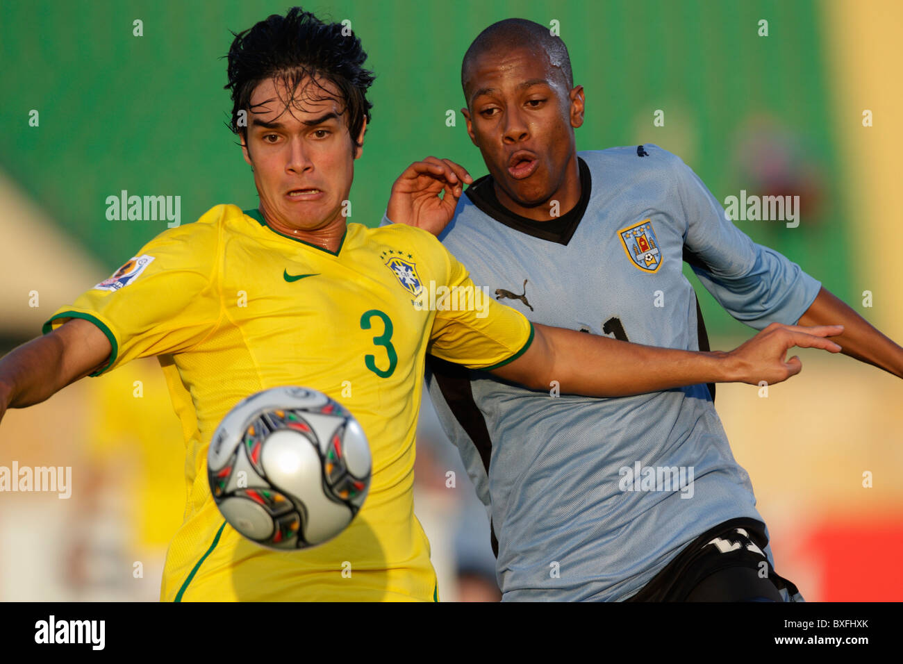 Dalton of Brazil (l) and Abel Hernandez of Uruguay (r) eye the ball during a 2009 FIFA U-20 World Cup round of 16 soccer match. Stock Photo