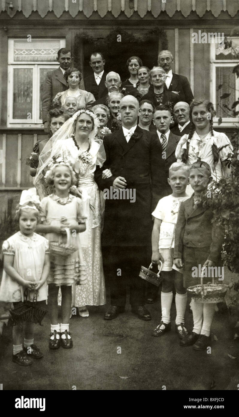 Germany, circa 1936, wedding, bridal couple, bride, groom, marriage, fashion, people, family, generations, group picture, children, kids, strew flowers, grandson, granddaughter, uncle, aunt, relatives, luck, 1930s, 30s, 20th century, , Additional-Rights-Clearences-Not Available Stock Photo