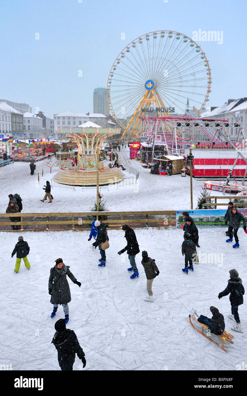Ice skating rink and funfair in winter in the snow, Ghent, Belgium