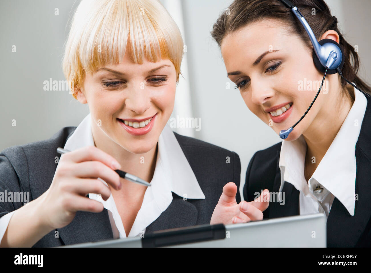 Portrait of two attractive business women working together Stock Photo ...
