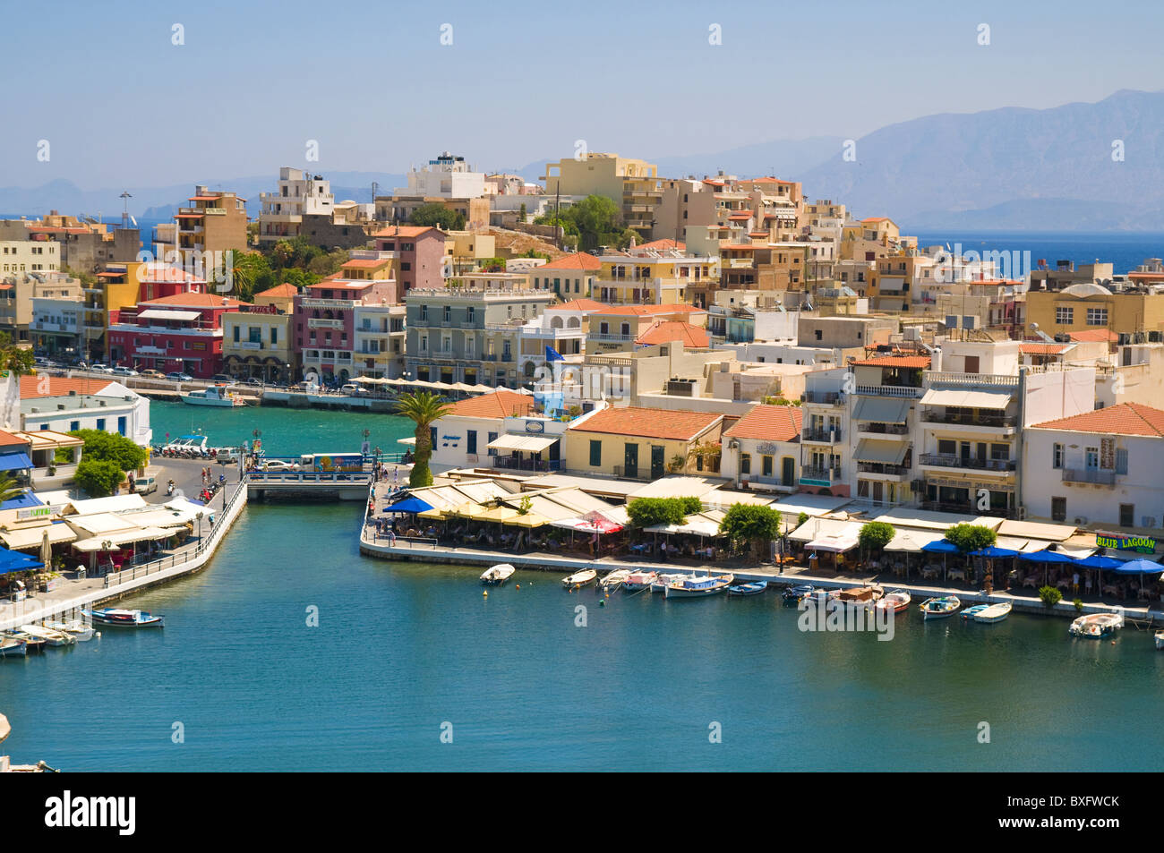 Lake Voulismeni with bridge and houses in Agios Nikolaos, Crete Stock Photo