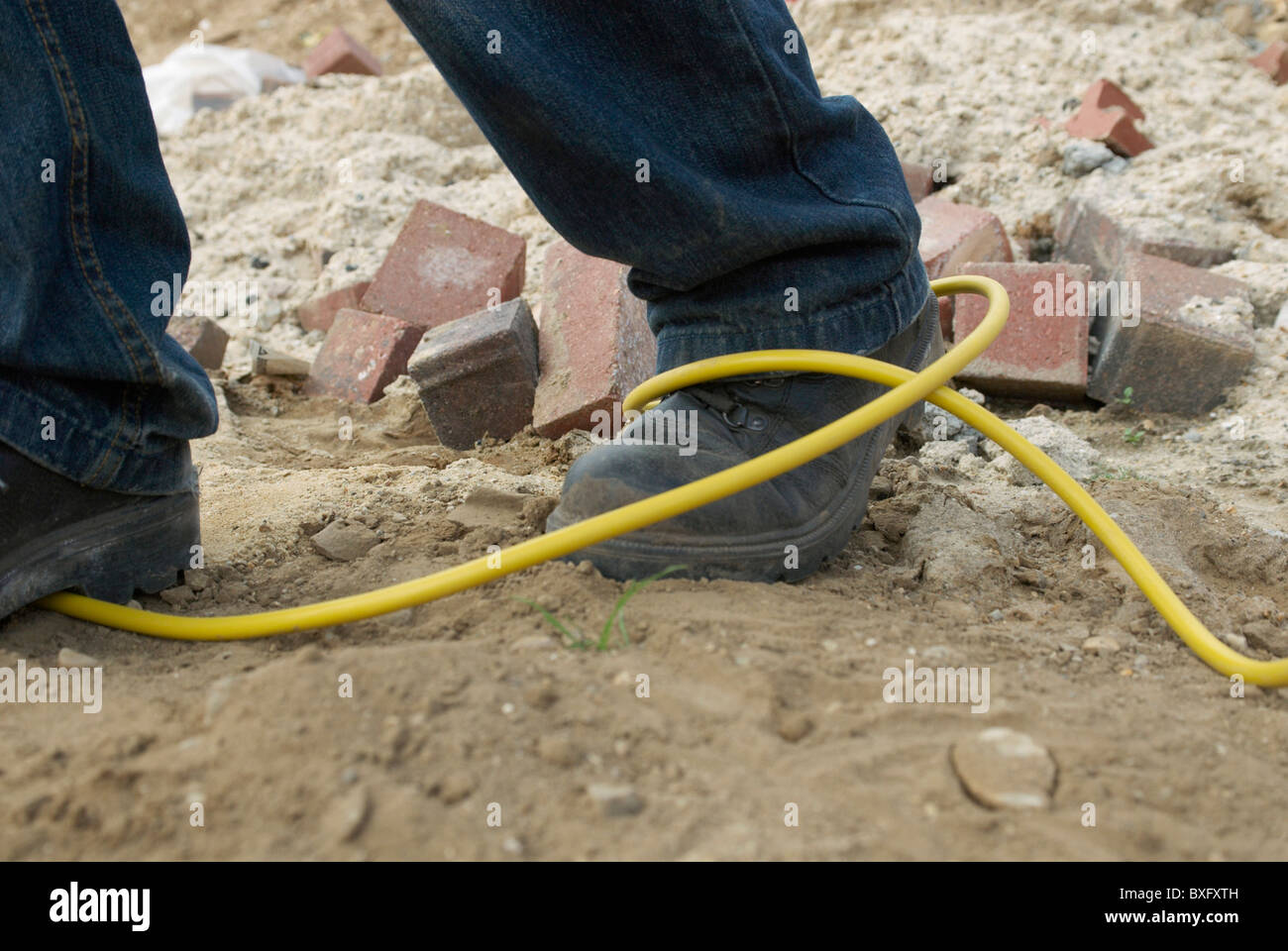 Site hazard tripping over an electric cable Stock Photo Alamy