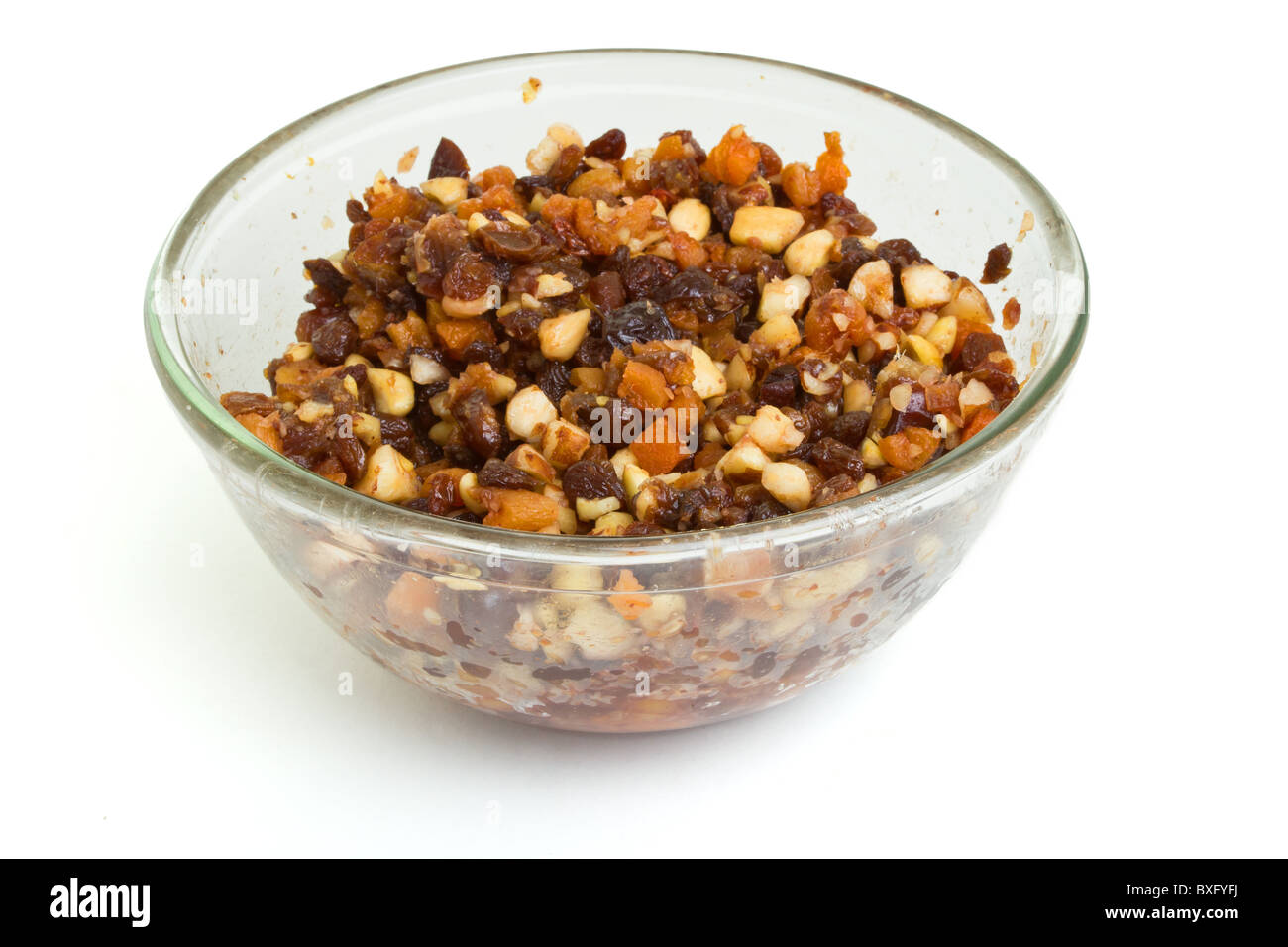 Glass bowl Xmas Cake Mix of nuts and soft fruits soaking up added rum, brandy and sherry. Stock Photo