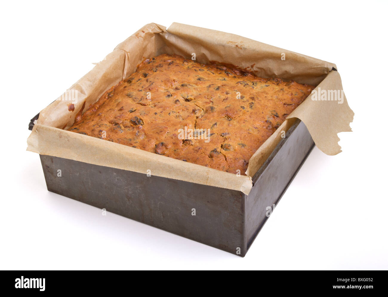 Square christmas fruit cake in baking tin just removed from oven. Stock Photo