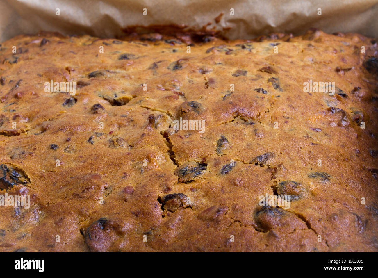 Square christmas fruit cake in baking tin just removed from oven. Stock Photo
