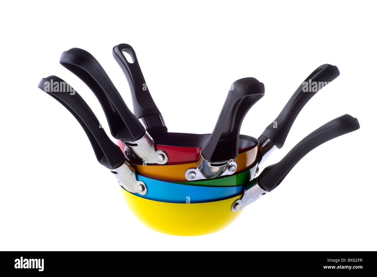 Many stacked colorful frying pans isolated over white Stock Photo
