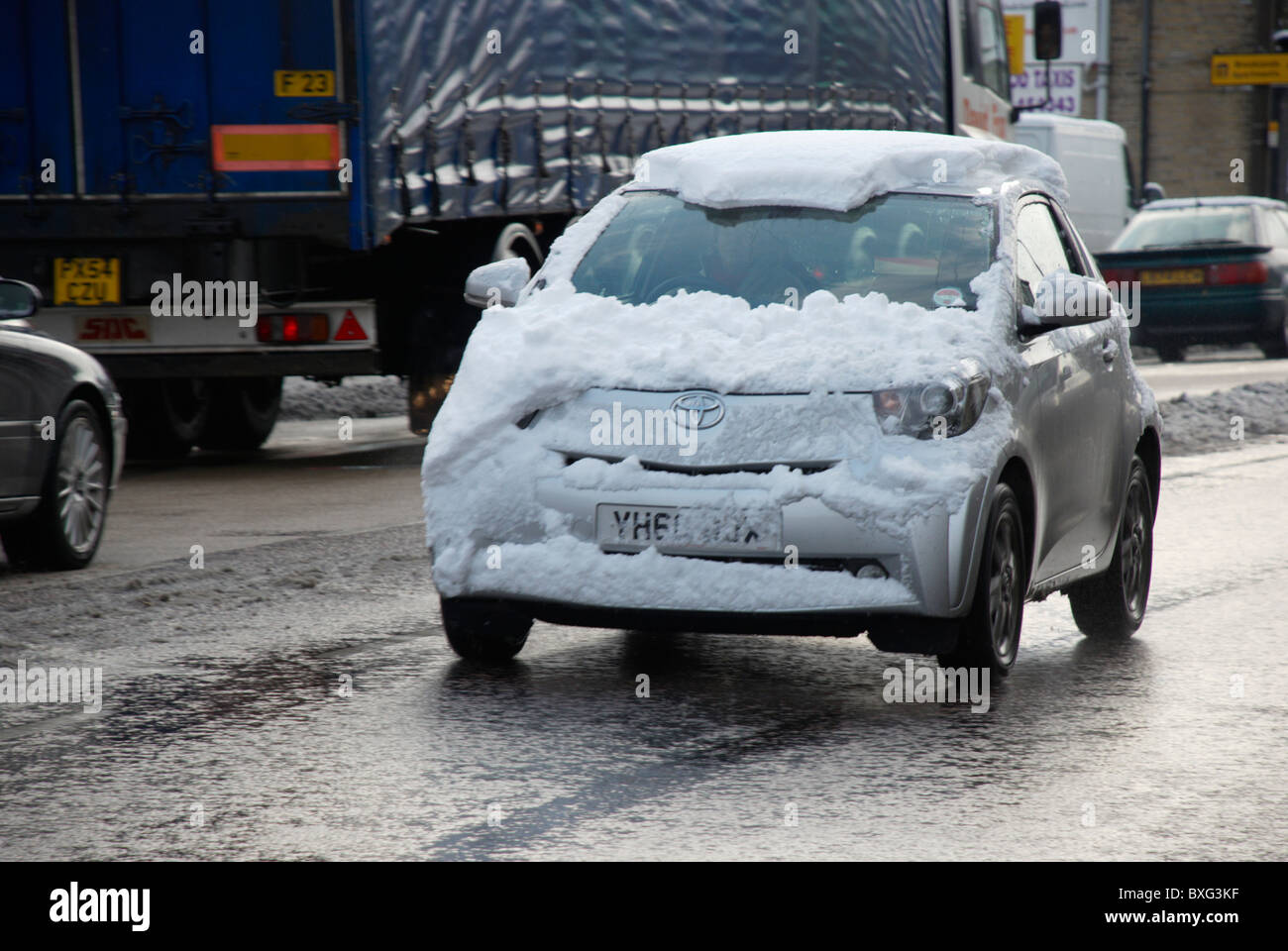 Camouflaged Toyota iQ covered in snow. Stock Photo