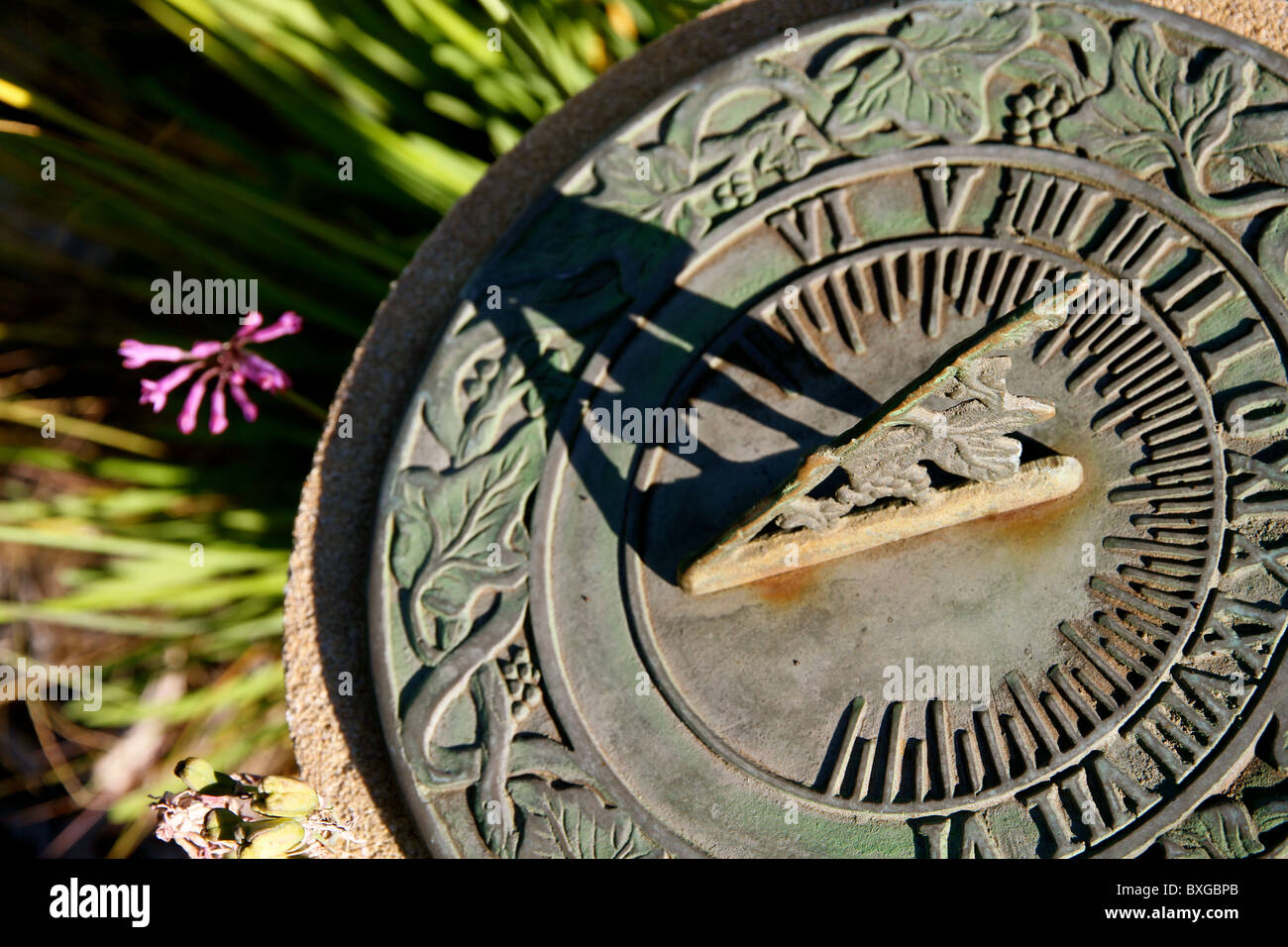 Antique bronze sundial in setting sun in a garden Stock Photo - Alamy
