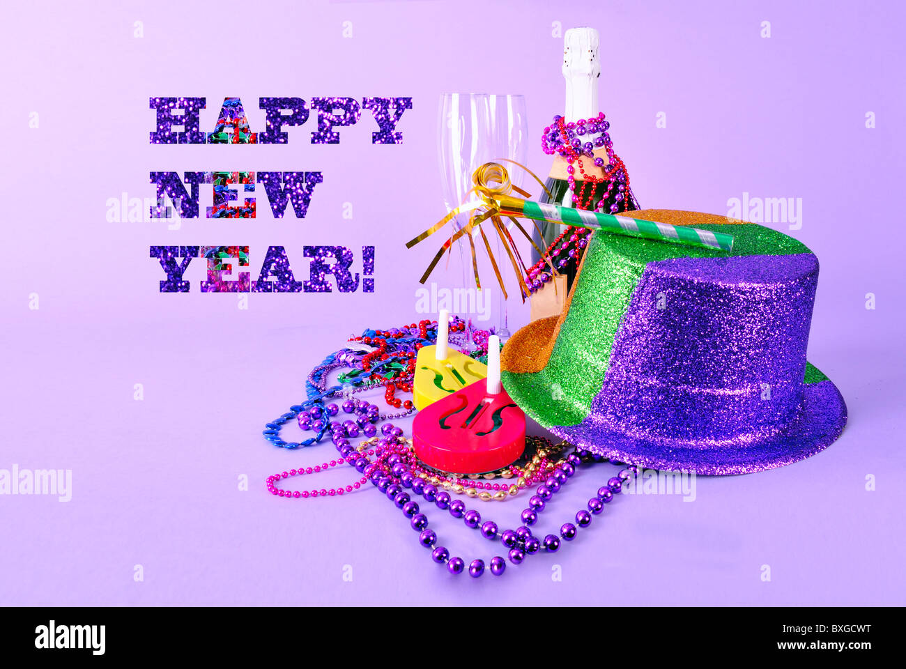 Happy New Year card New Years Eve invitation 2011 with party favors and champagne bottle flutes noisemakers party  hat and beads Stock Photo