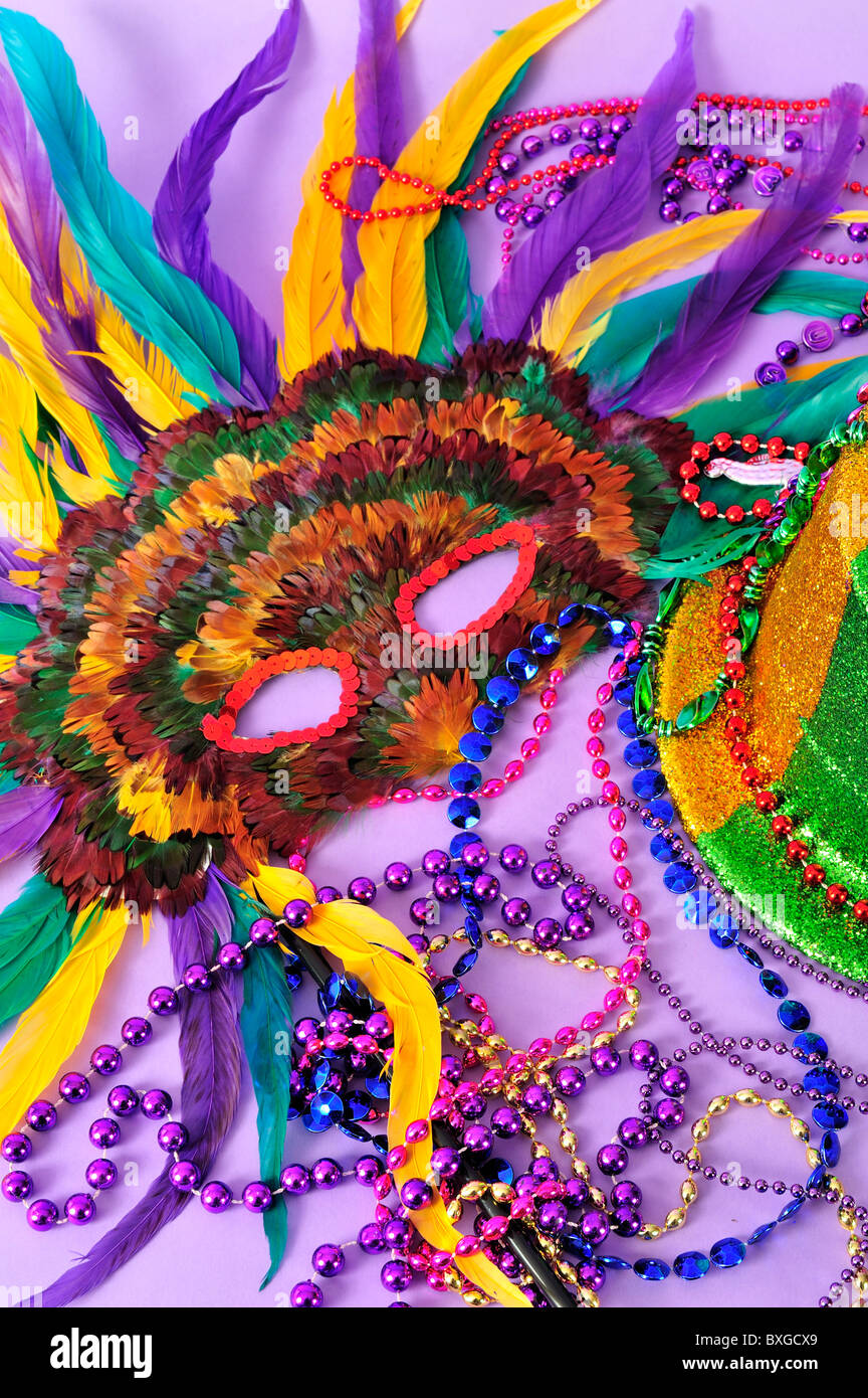 Mardi Gras still life feathered masks shiny party hat beads close up series also  coordinating backgrounds see description Stock Photo