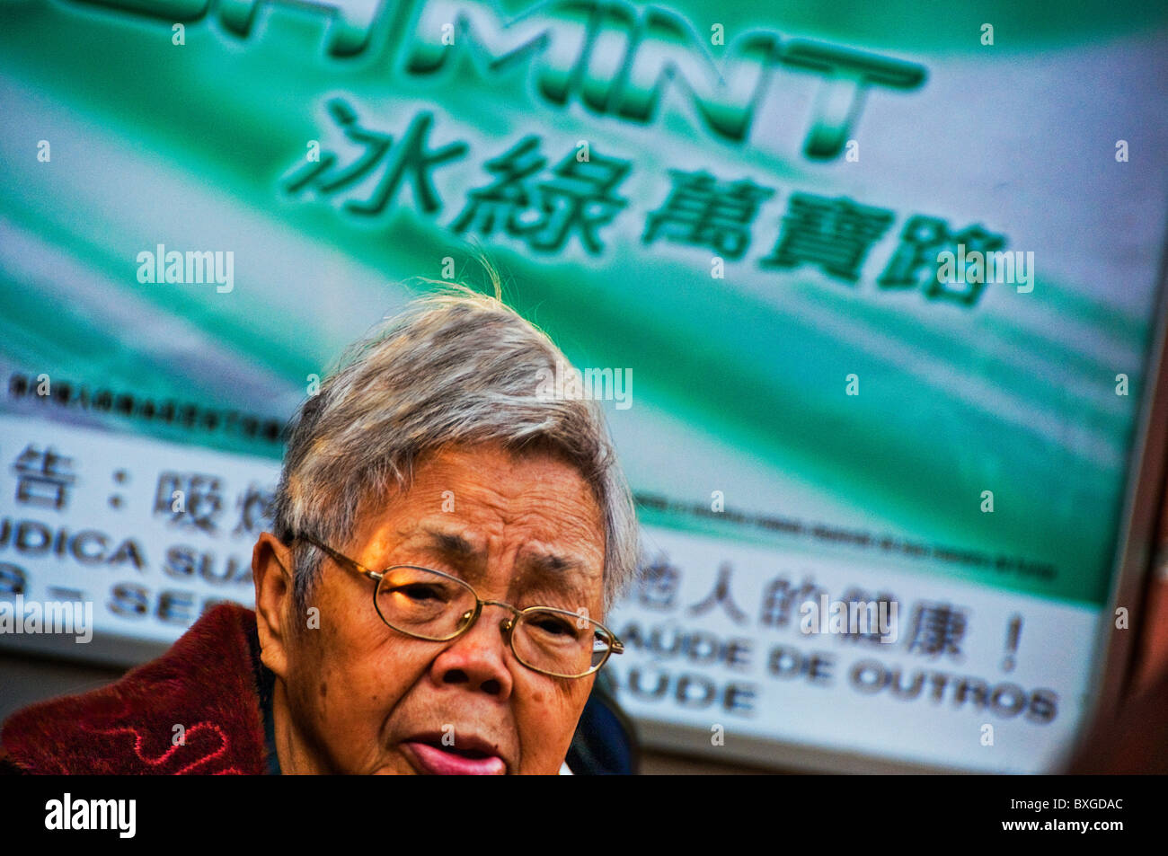 Expressive older Asian woman with head of full gray hair Stock Photo