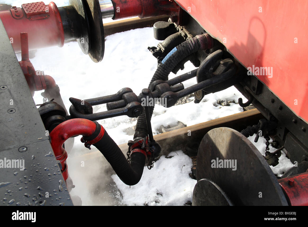 Air coupling, buffers and coupling links on steam locomotive and carriages. Stock Photo
