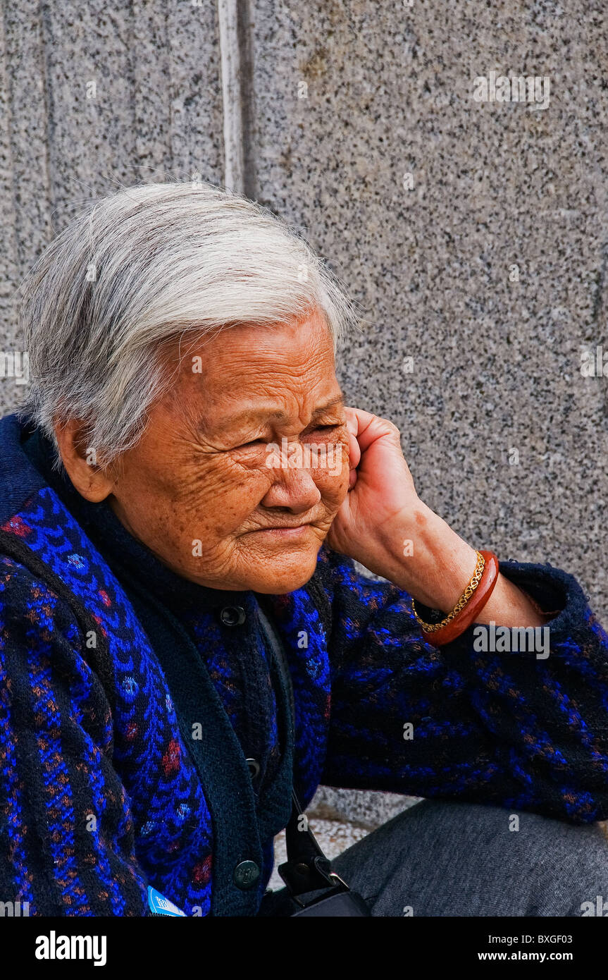Expressive Older Asian Woman With Head Of Full Gray Hair
