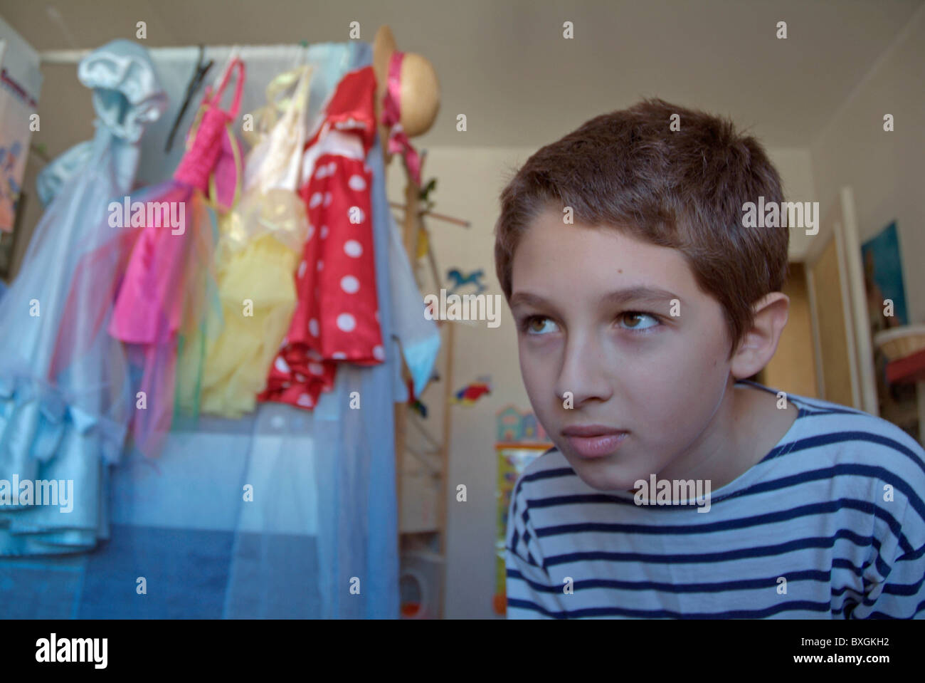 Young boy searching for a toy in his sister's bedroom. Stock Photo