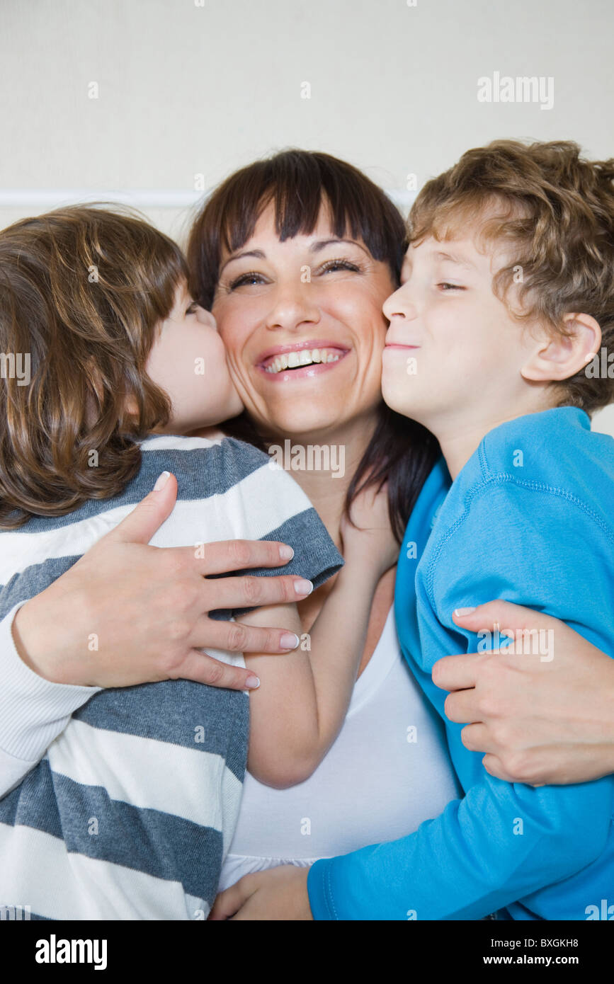 Children kissing happy mother Stock Photo - Alamy